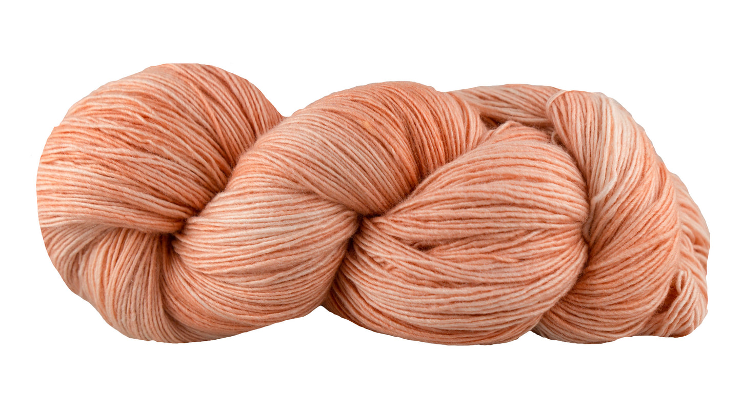 Fairmount Fibers Fino yarn in Ballgown color, showcasing soft, luxurious wool yarn with vibrant pink and purple hues.