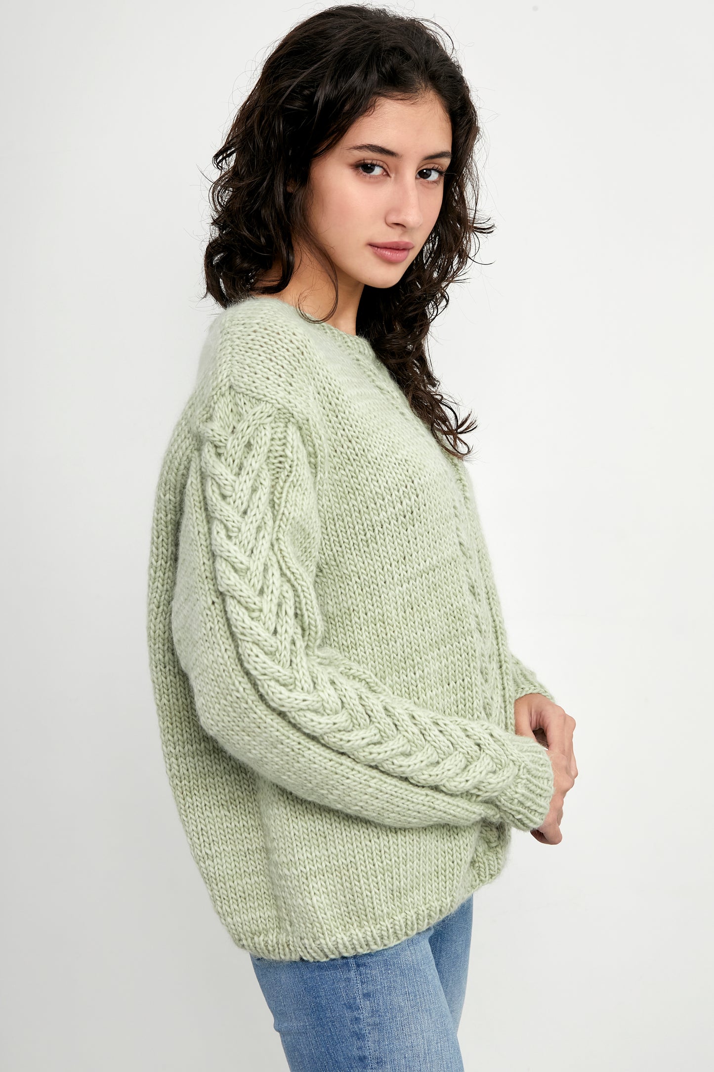 Colorful patterned sweater from Kinua's The Monet collection, featuring a vibrant aquacolor design with intricate knit details.