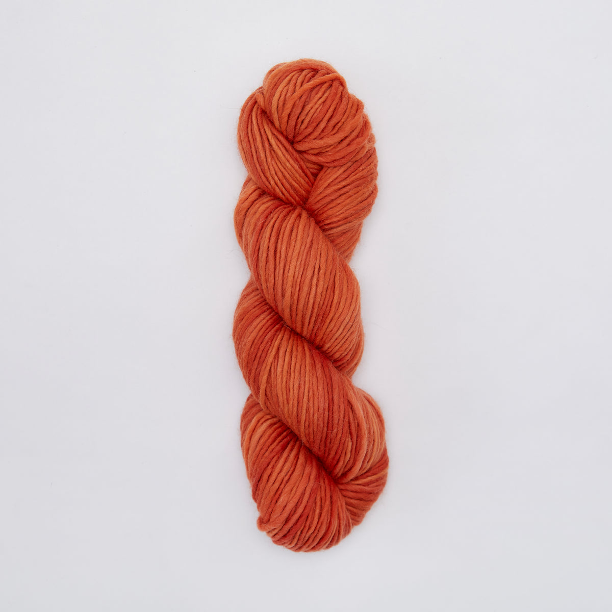 Kinua The Skinny Luxury Blend yarn in pumpkin orange, showcasing its soft texture and vibrant color for knitting or crochet projects.