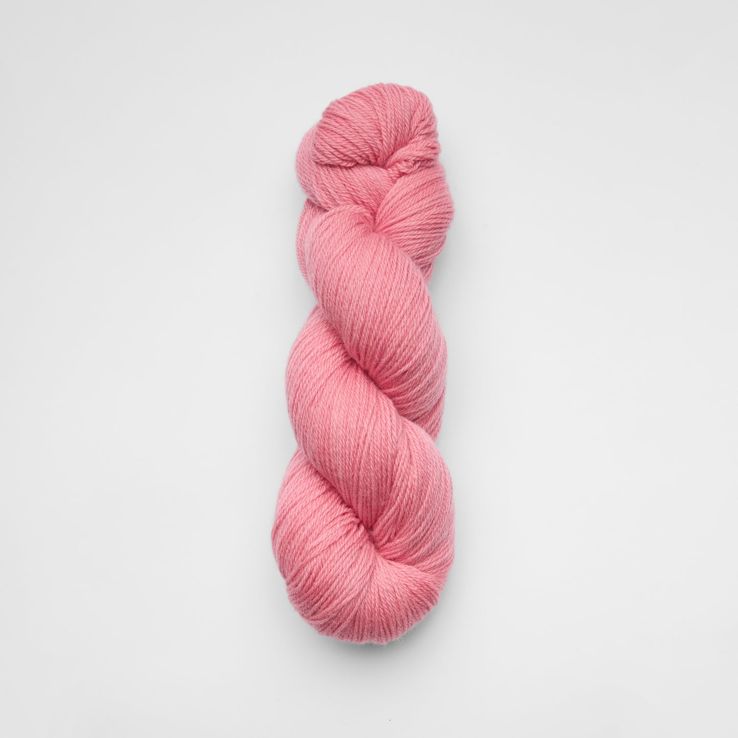 Kinua The Fingering Luxury Blend yarn in pink, lemon, and beige tones, showcasing soft, high-quality knitting yarn with colorful stripes.