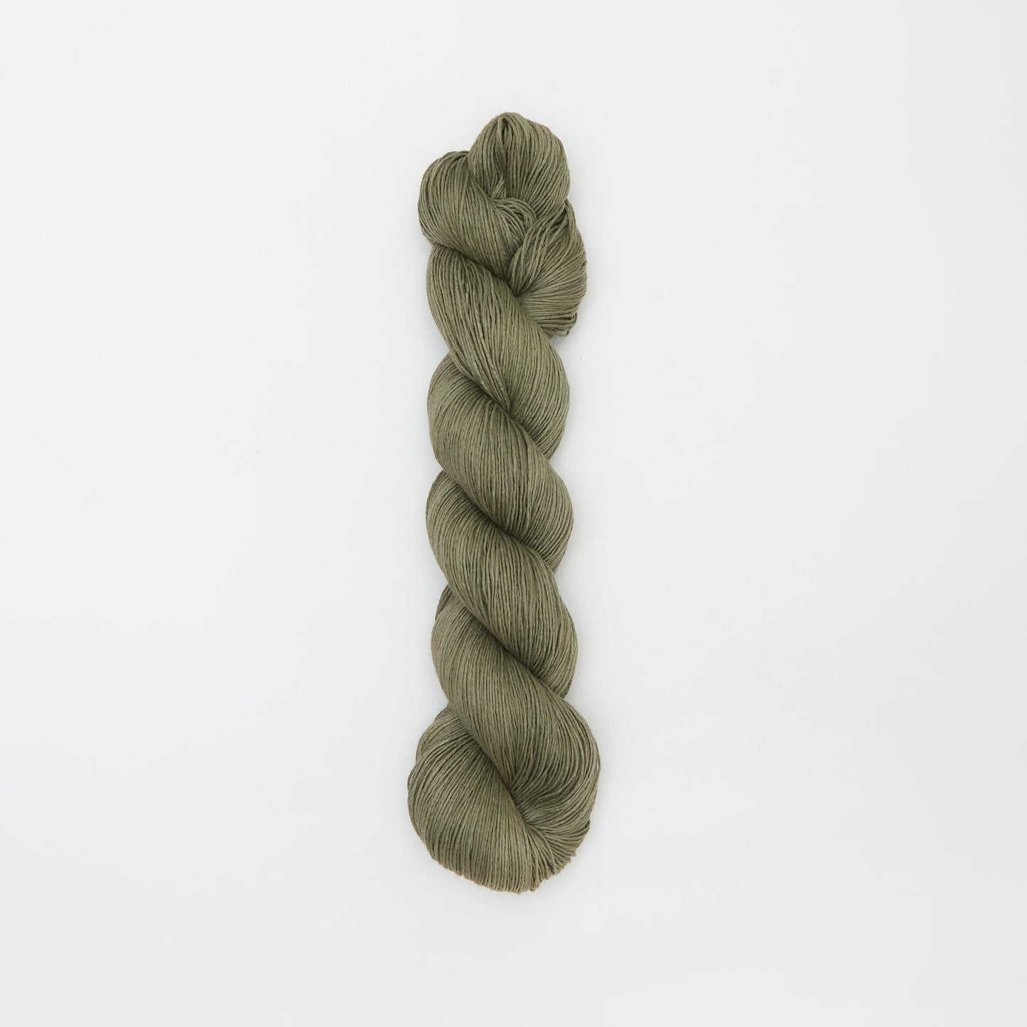 Kinua Fingering Organic Cotton yarn in pistachio green, showing soft, twisted fiber strands ideal for knitting or crochet projects.