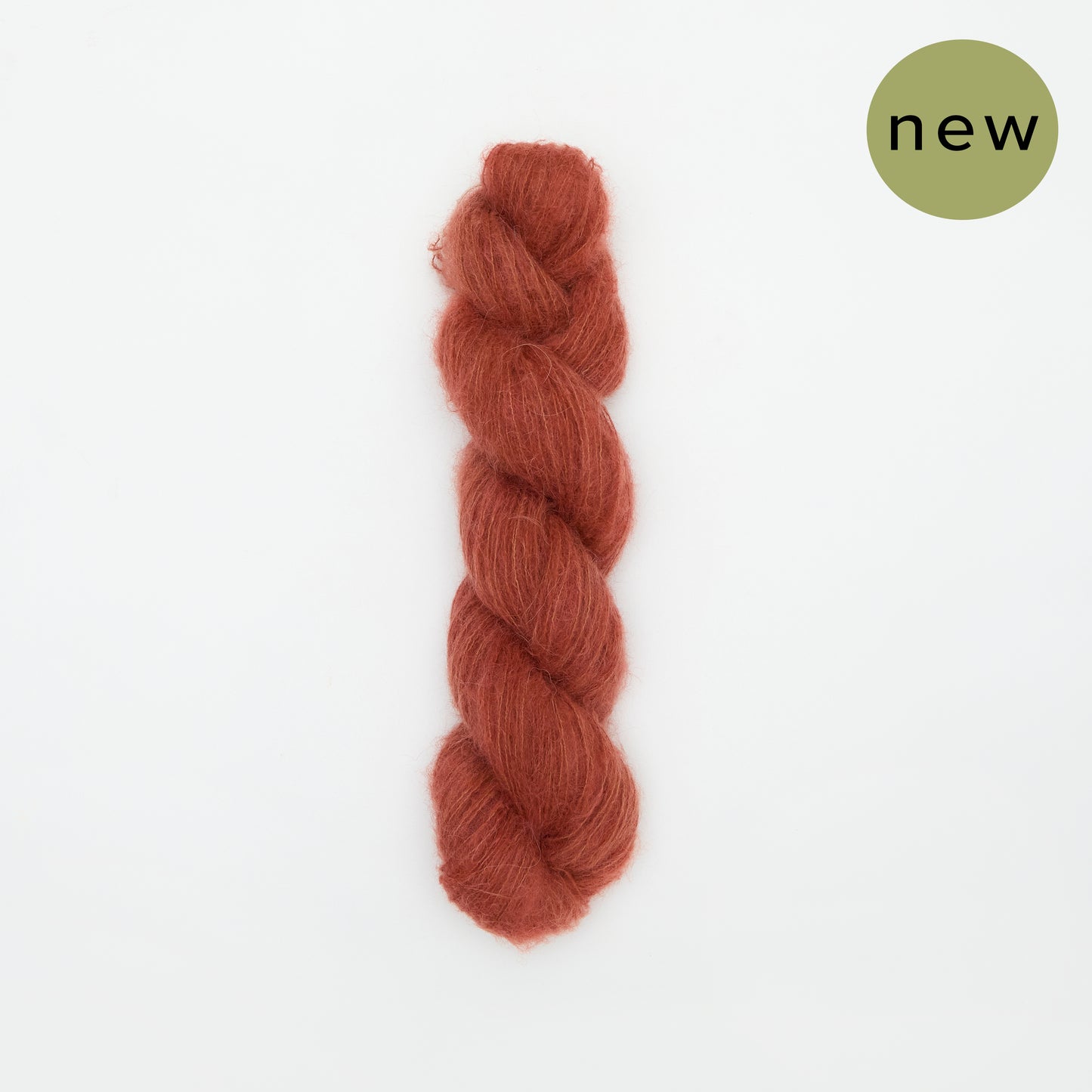 Kinua The Fuzzy yarn in chili pepper color, soft and textured yarn for knitting and crochet projects.