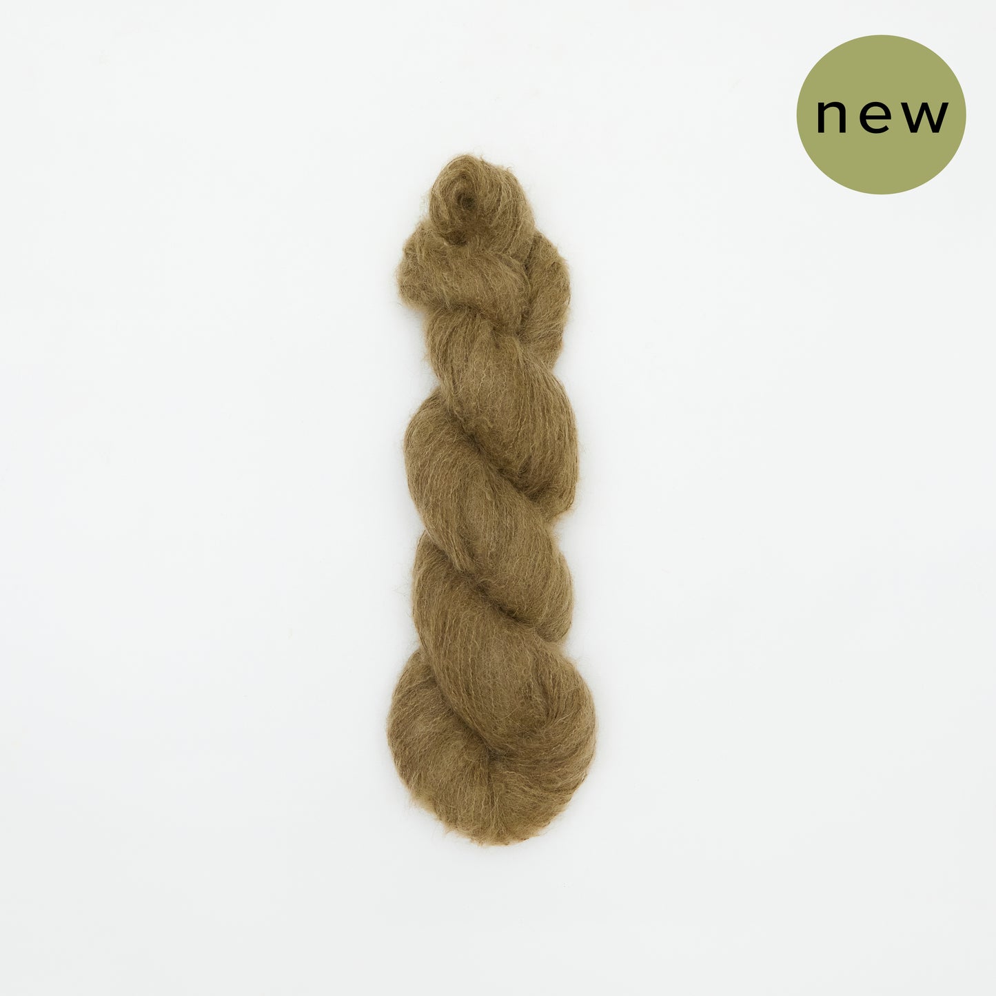 Dark oak-colored Kinua The Fuzzy yarn ball showing its soft, fuzzy texture and rich color in close-up shot.