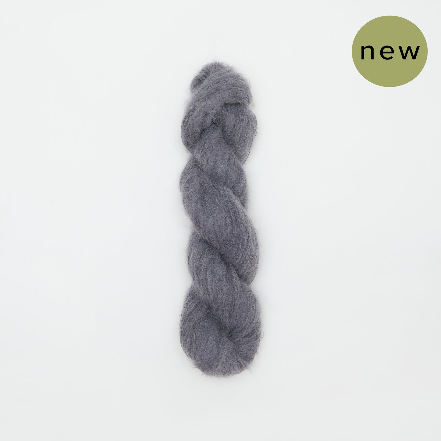 Kinua The Fuzzy charcoal yarn ball, soft and textured, showcasing its fuzzy, cozy appearance perfect for knitting projects