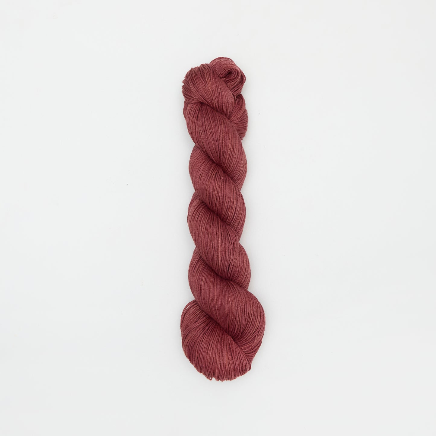 Kinua Fingering Organic Cotton yarn in copper color, showcasing soft, high-quality organic cotton fibers for knitting or crochet projects.