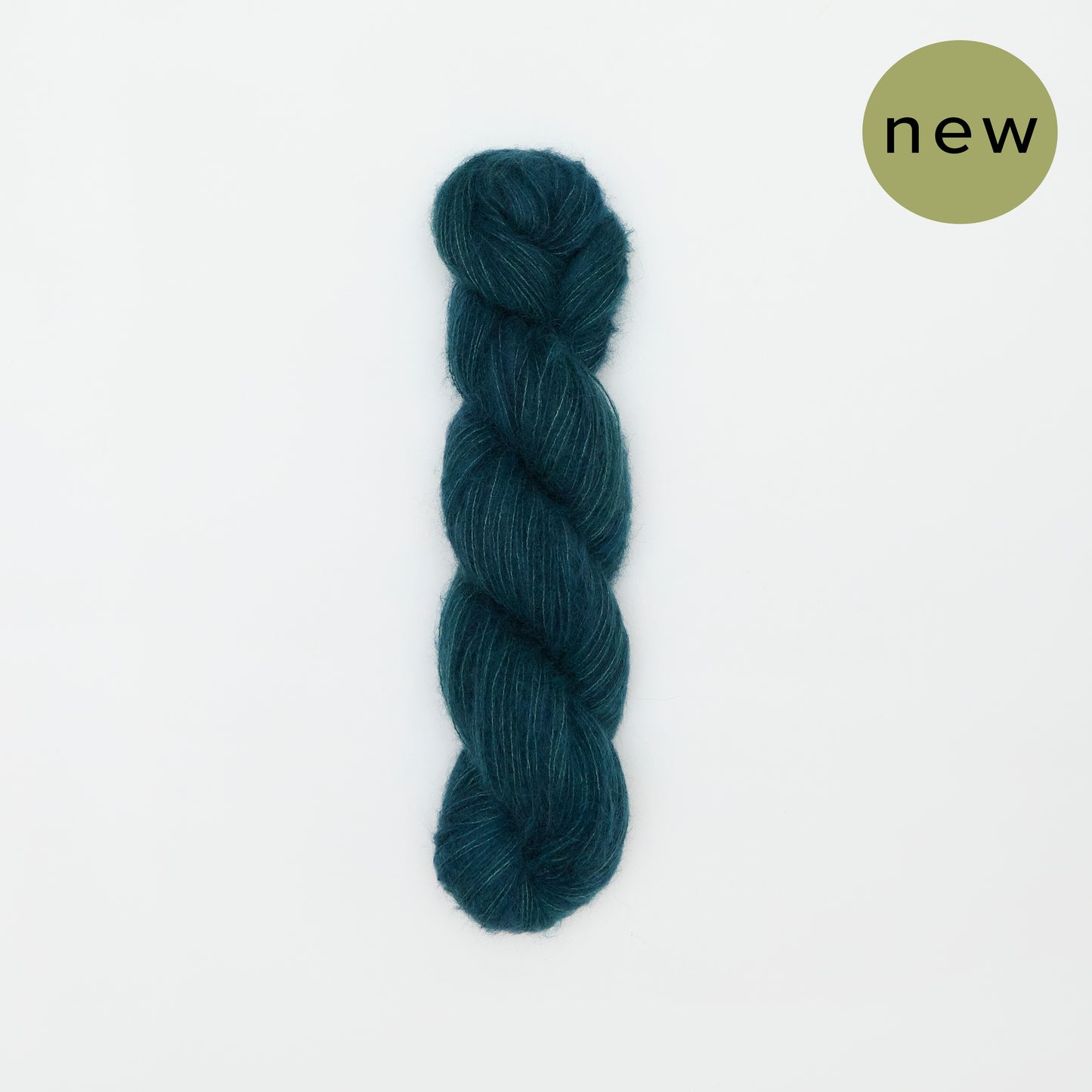 Kinua The Fuzzy teal yarn ball with soft, fuzzy texture, ideal for cozy knitting projects.
