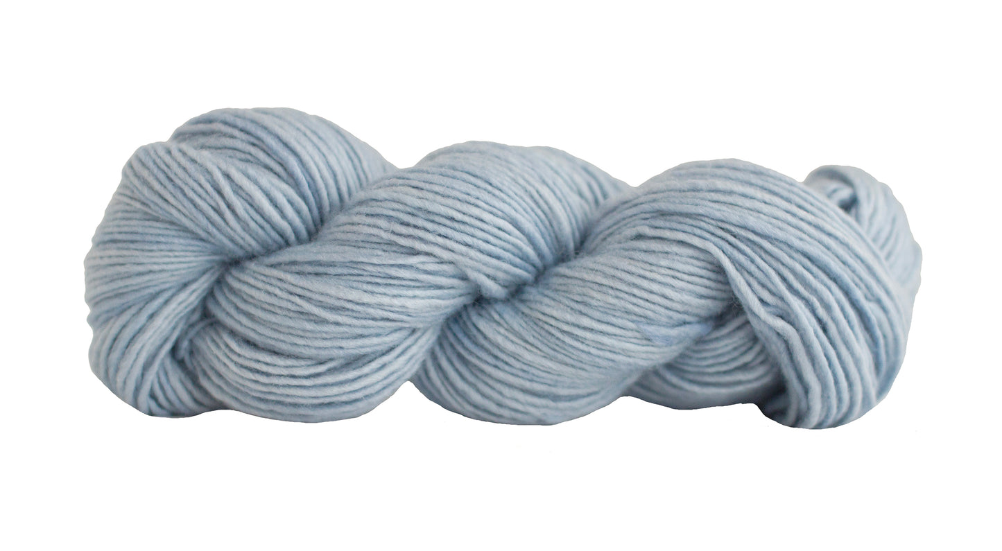 Soft silk blend yarn from Manos del Uruguay in powder color, showcasing its smooth texture and vibrant hue.