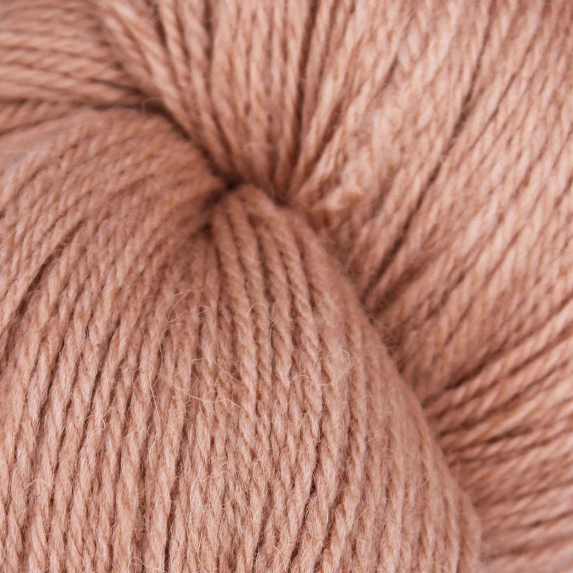 Baa Ram Ewe Coast yarn in Seashell color, soft and textured wool skein suitable for knitting or crochet projects.