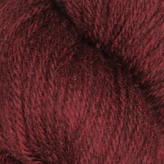 Baa Ram Ewe Coast yarn in a vibrant color, showing a close-up of the soft, textured wool fibers.