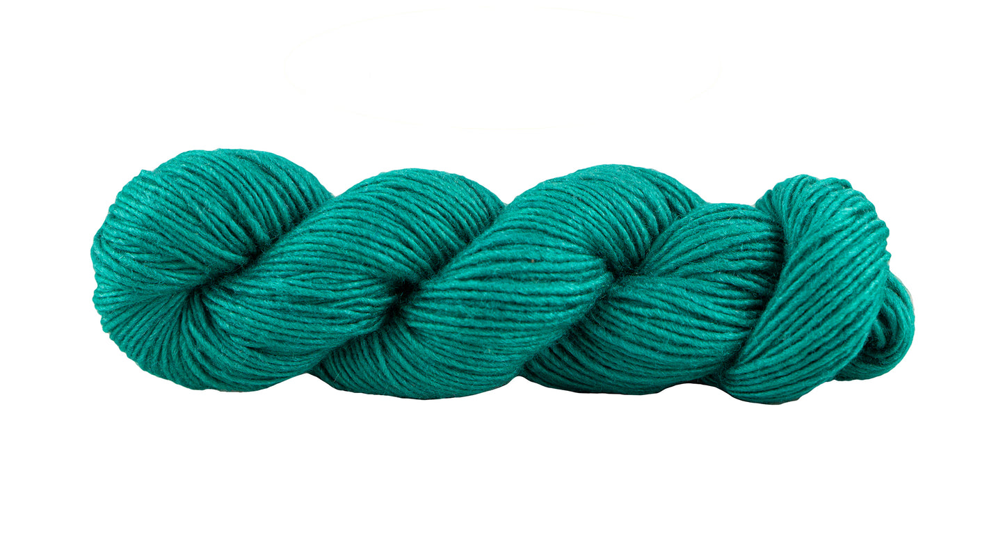 Manos del Uruguay Silk Blend yarn in rich emerald green, showcasing the soft, luxurious fiber and vibrant color for knitting or crochet projects.