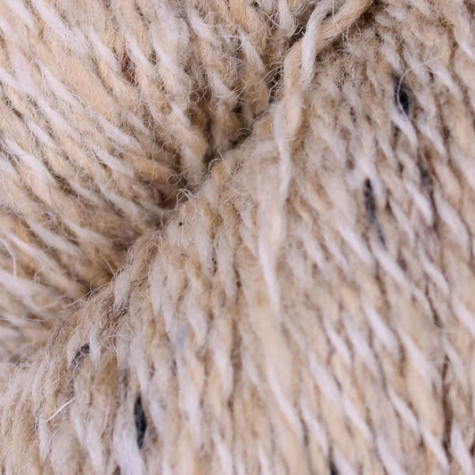 Baa Ram Ewe Donegal Twists yarn in natural shades, showing textured, colorful spun wool for knitting or crochet projects.
