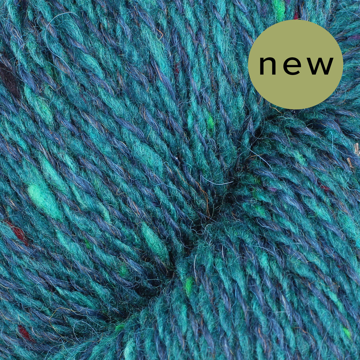 Close-up of Baa Ram Ewe Donegal Twists yarn in natural light, showcasing its textured, speckled appearance and vibrant color.