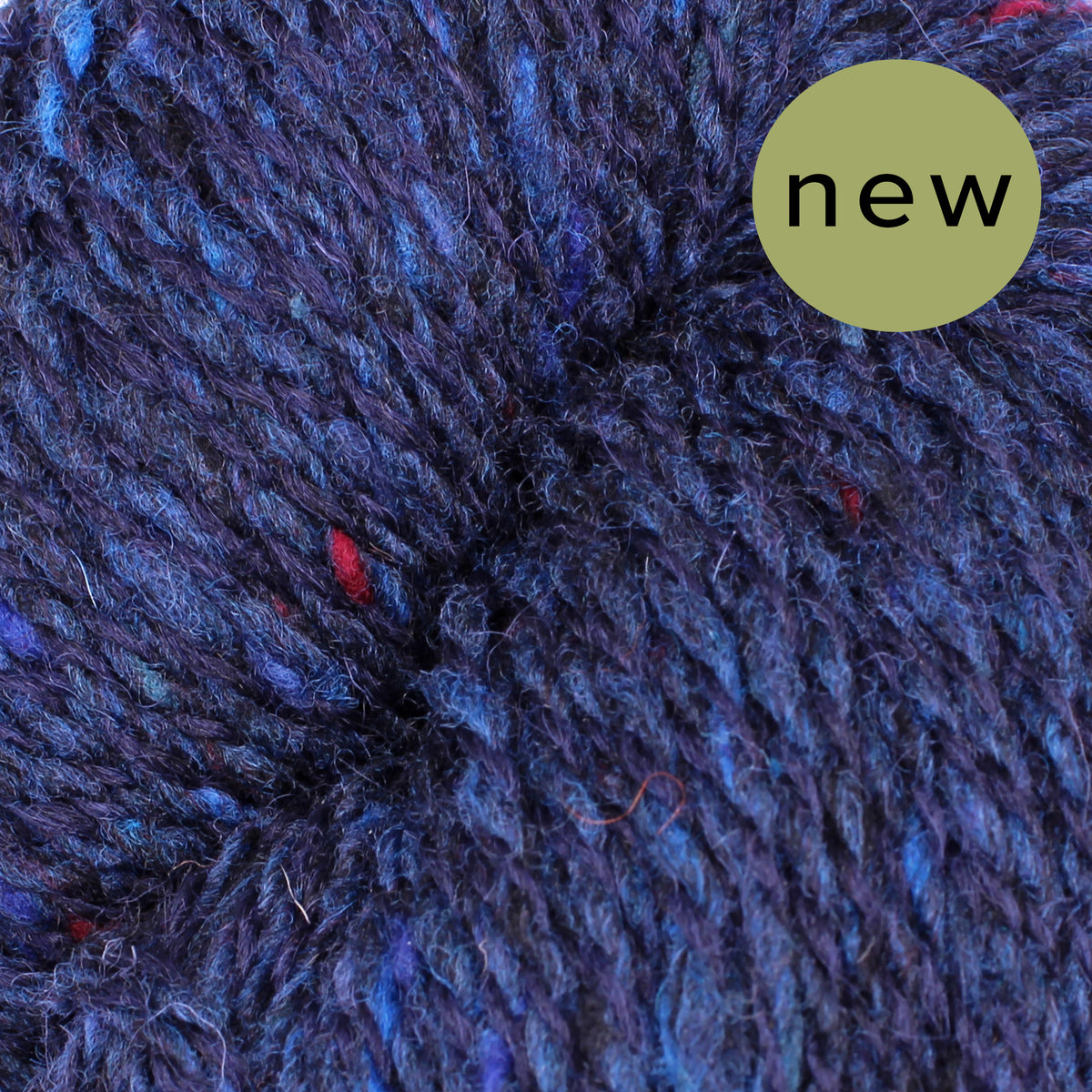 Baa Ram Ewe Donegal Twists yarn in natural cream color, showcasing the textured, twisted wool fibers perfect for knitting projects.