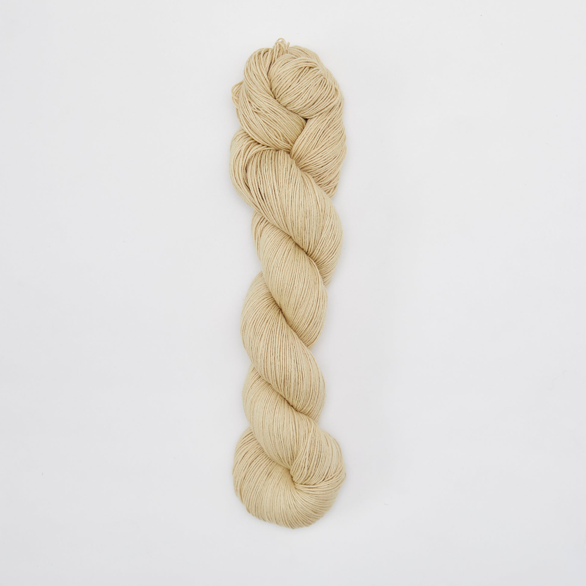 Kinua Fingering Organic Cotton yarn in Chamomile color, showing soft, natural fiber strands suitable for knitting or crochet projects.