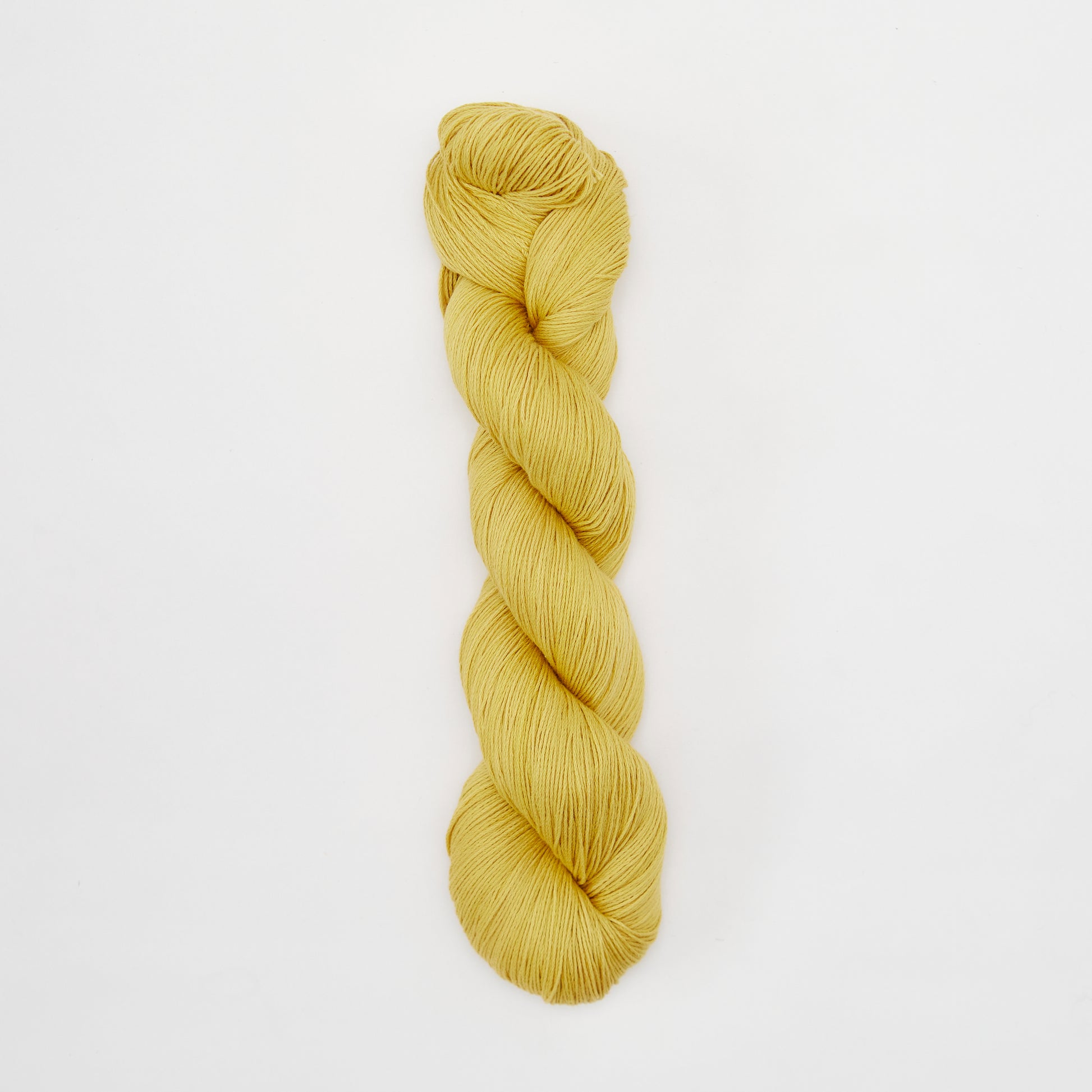 Golden Kinua Fingering Organic Cotton yarn, soft and natural, perfect for knitting and crochet projects.