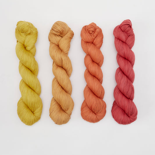 Organic cotton yarn from Kinua, The Fingering type, shown in soft, natural fibers suitable for knitting and crochet projects.