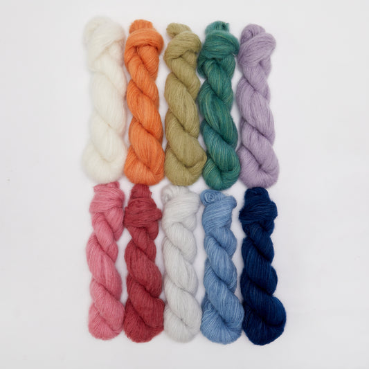 Close-up of Kinua The Fuzzy yarn in soft, plush texture with vibrant colors and thick, cozy fibers.