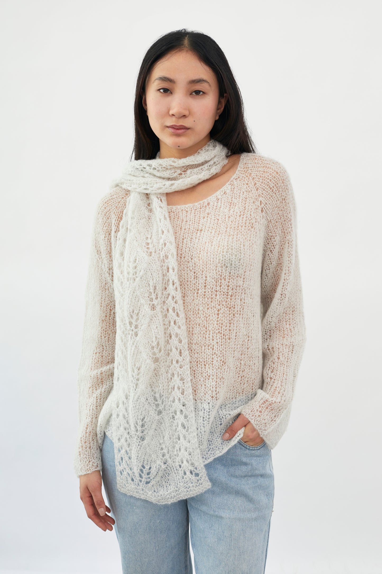 Close-up of Kinua fuzzy patterned scarf showing soft, cozy fabric with a vibrant, stylish design.