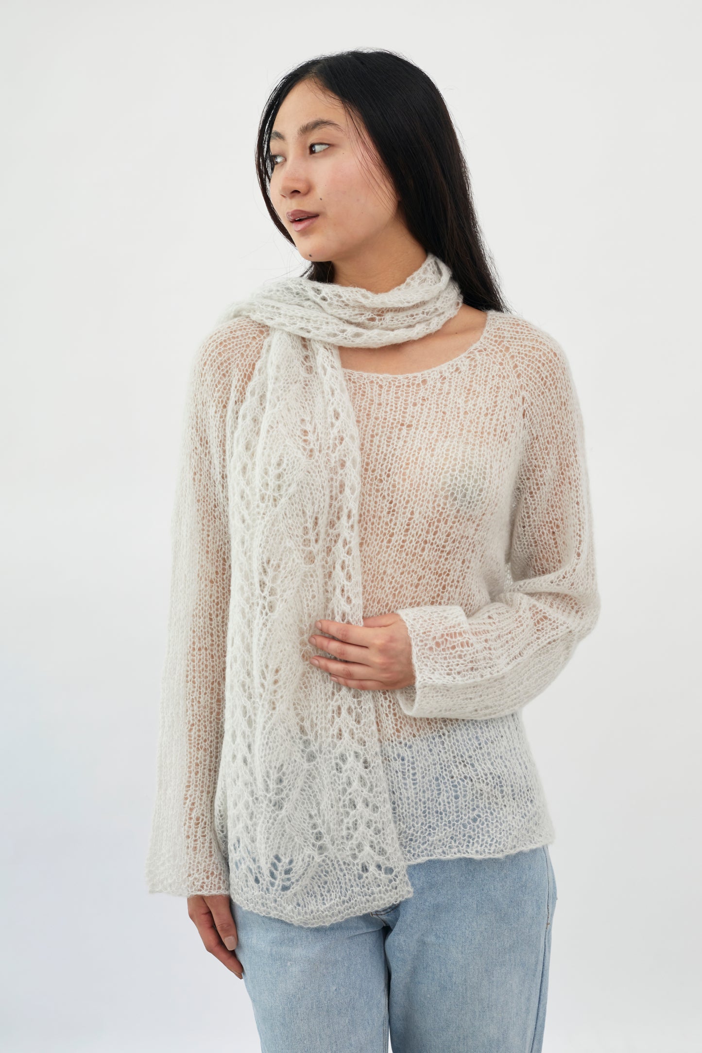 Patterned fuzzy scarf by Kinua, featuring soft, cozy fabric and a stylish design ideal for cold weather.
