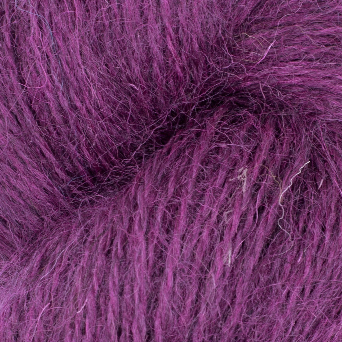 Colorful patchwork Mowool yarn by Baa Ram Ewe, showing thick and thin wool strands in a vibrant, textured knitting yarn display.