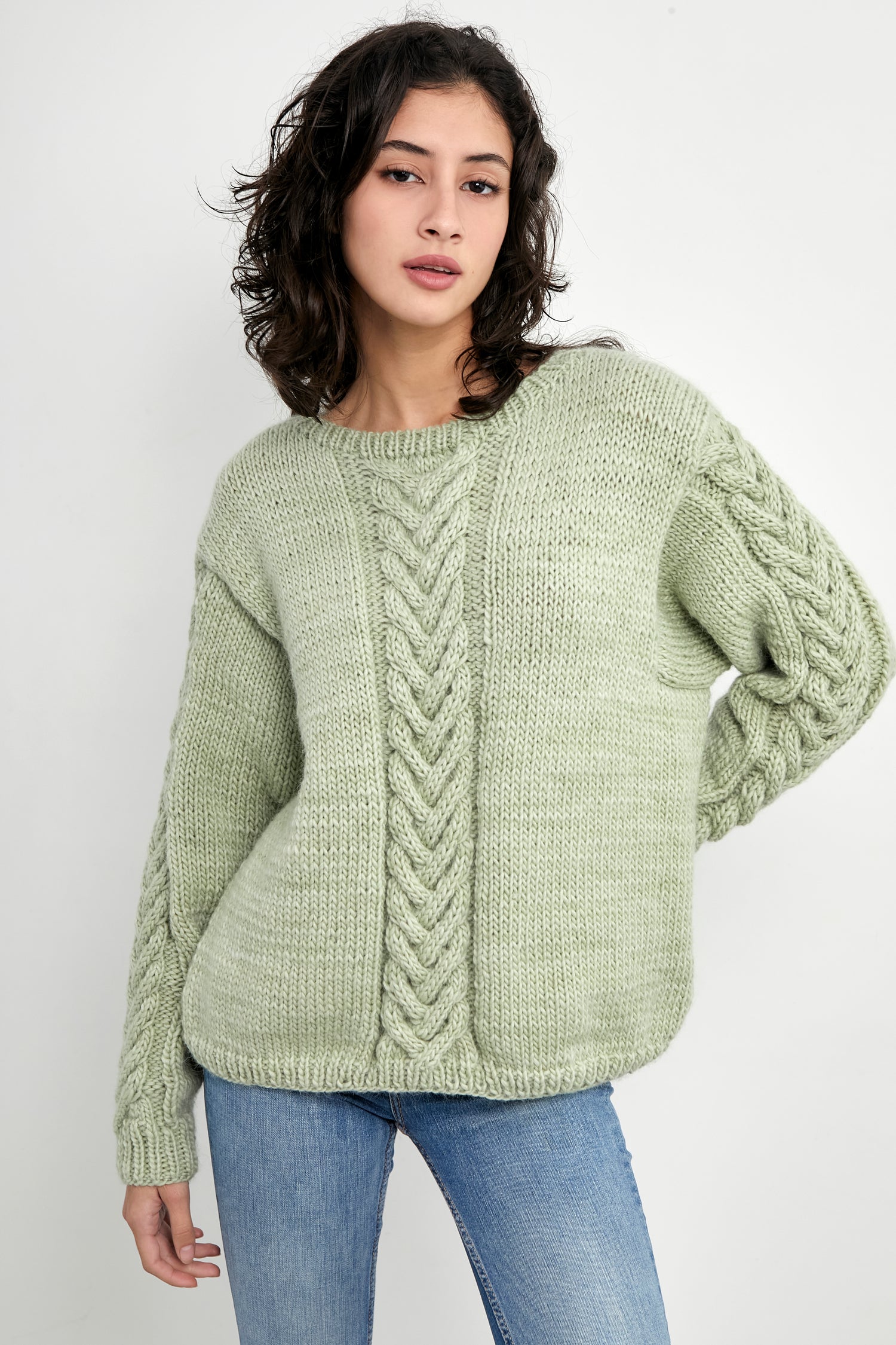 Kinua Monet Sweater featuring a colorful pattern in aqua tones, showcasing its soft texture and stylish design.