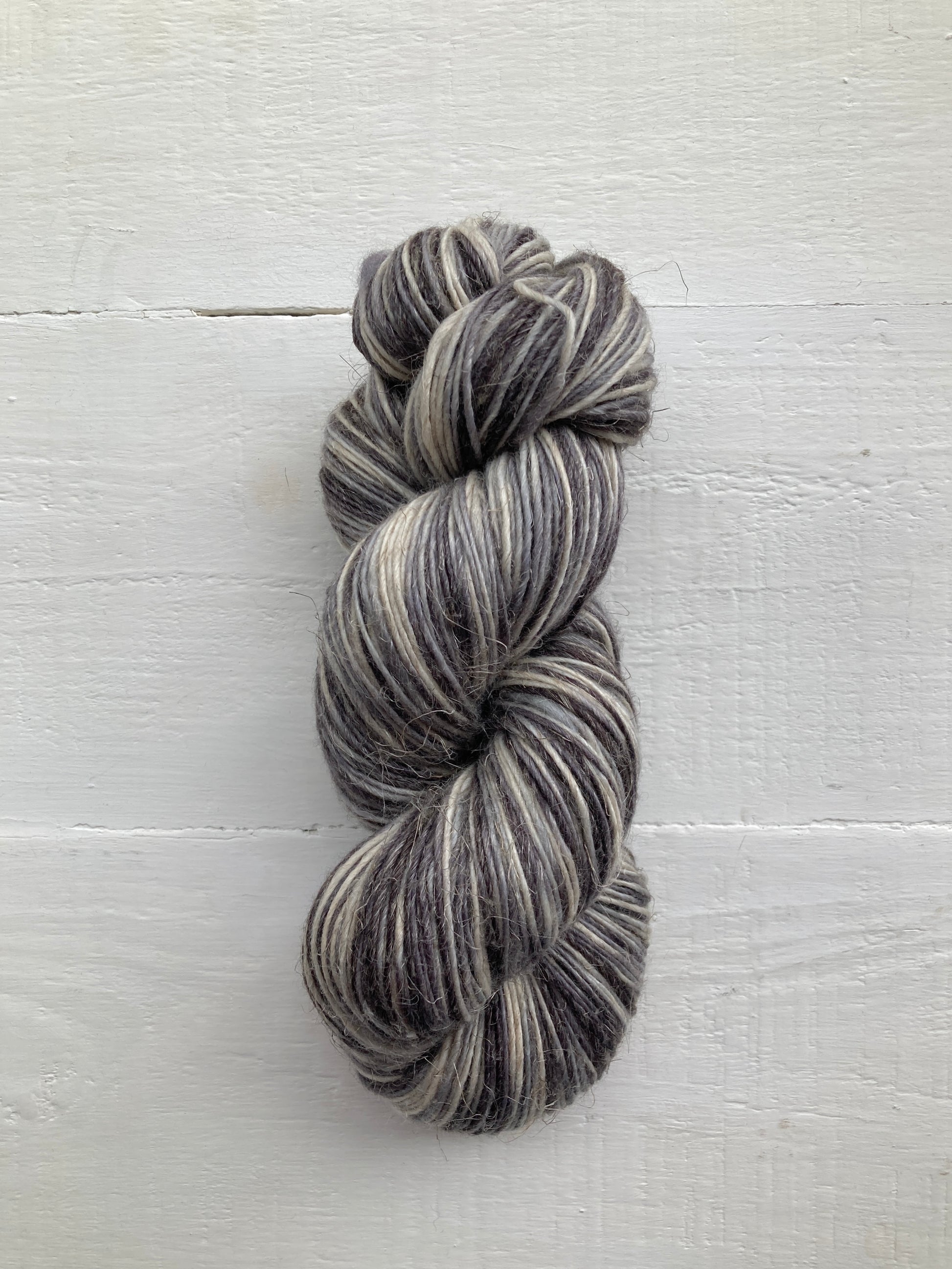 Manos del Uruguay Milo yarn in natural color, close-up of soft, textured wool fiber for knitting and crochet projects.